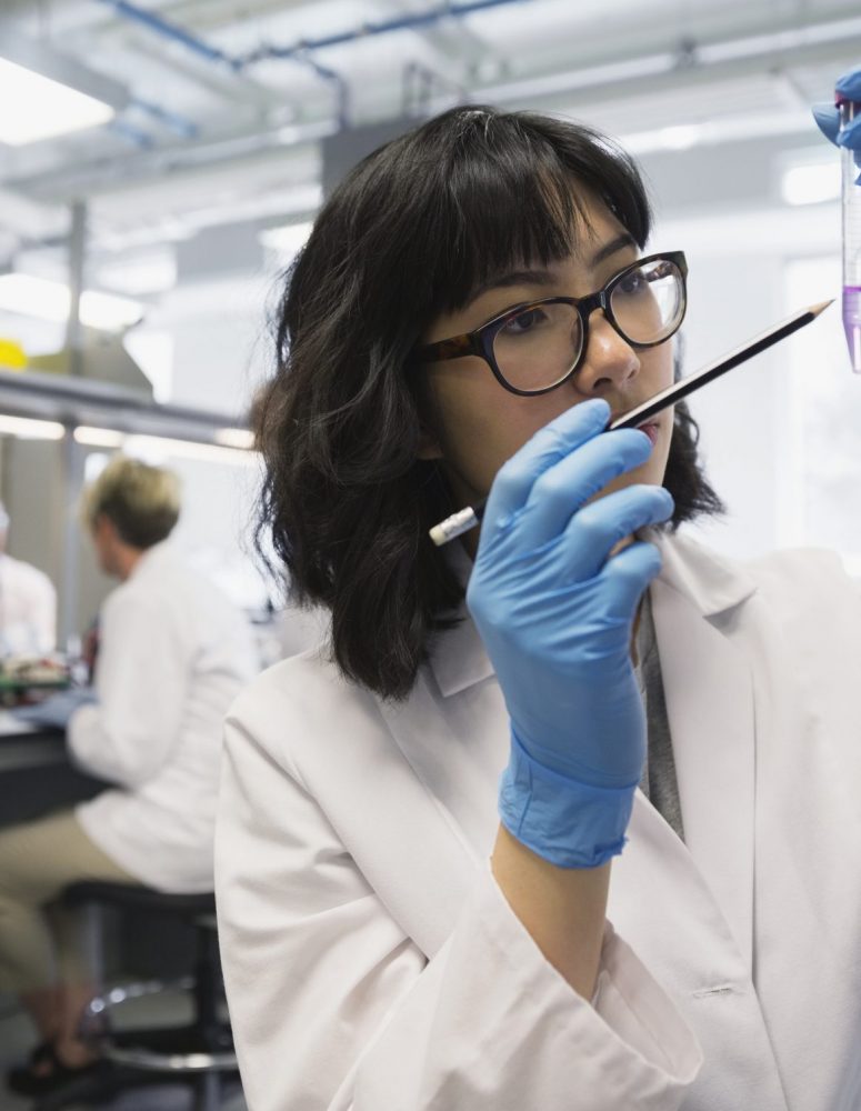 Scientist examining liquid in test tube in laboratory
