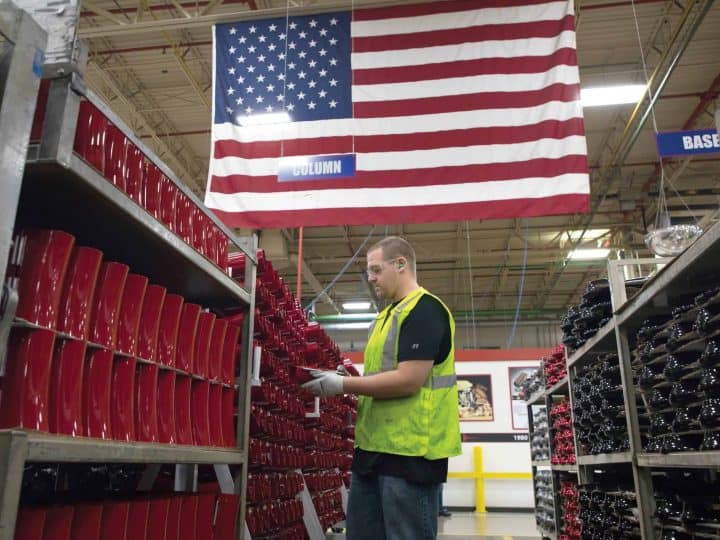 Manufacturing Worker With Flag in Background