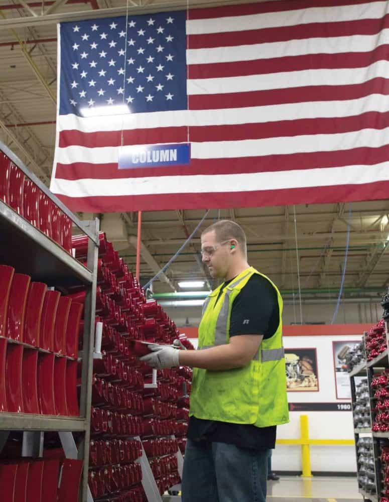 Manufacturing Worker With Flag in Background