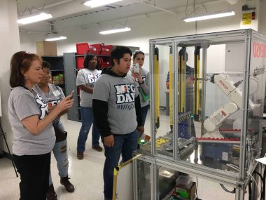 Students examining equipment at DENSO