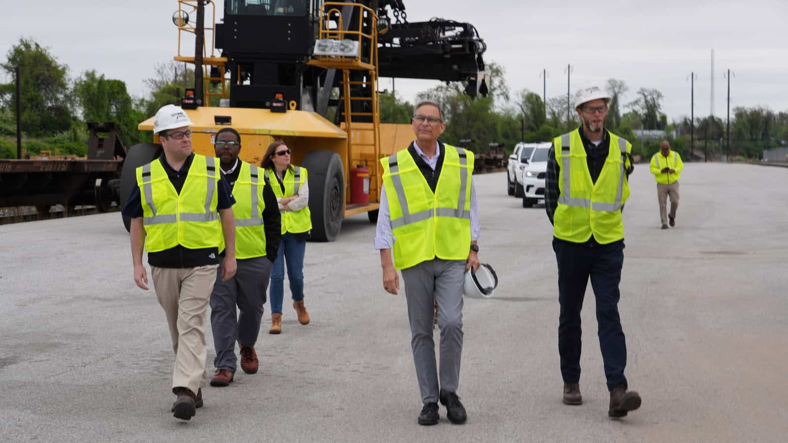 a group of people standing on the side of a road